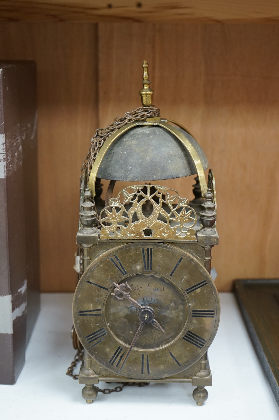 An 18th century lantern clock with pendulum and weight, the dial inscribed Philip Wardale, 37cm high